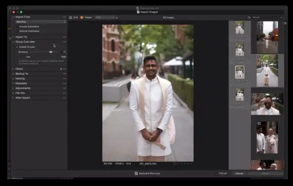 Mężczyzna w białej szacie ślubnej uśmiecha się do kamery. Capture One pozwala na import i grupowanie zdjęć.