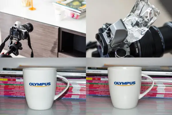 Aparat Olympus z lampą błyskową i dyfuzorem z folii aluminiowej, kubek Olympus na tle stosu magazynów.